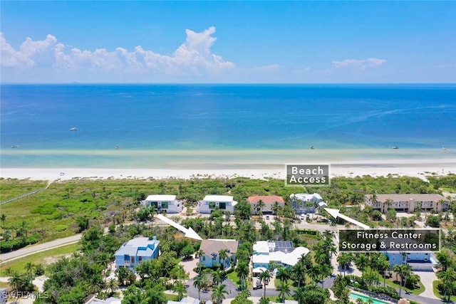 birds eye view of property featuring a water view and a beach view