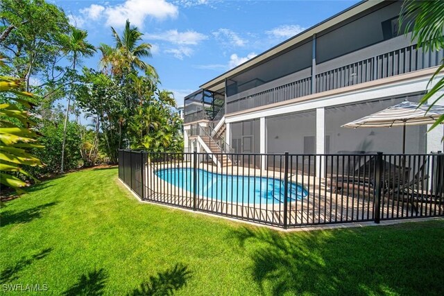 view of swimming pool with a yard and a patio