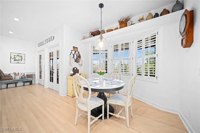 dining room featuring hardwood / wood-style flooring and french doors