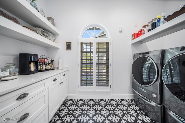 laundry room featuring cabinets, separate washer and dryer, and light tile patterned floors