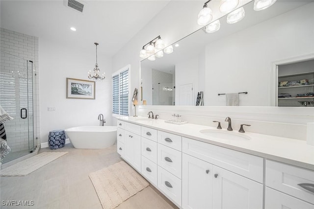 bathroom featuring vanity, a notable chandelier, and independent shower and bath