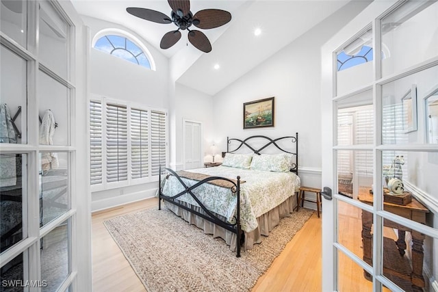 bedroom with ceiling fan, french doors, and light hardwood / wood-style floors