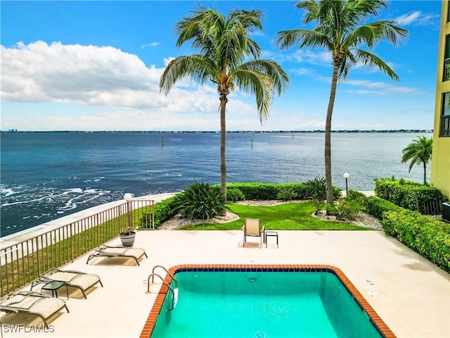 view of pool featuring a fenced in pool, a water view, a patio, and fence