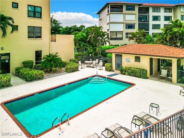 pool featuring a patio and fence