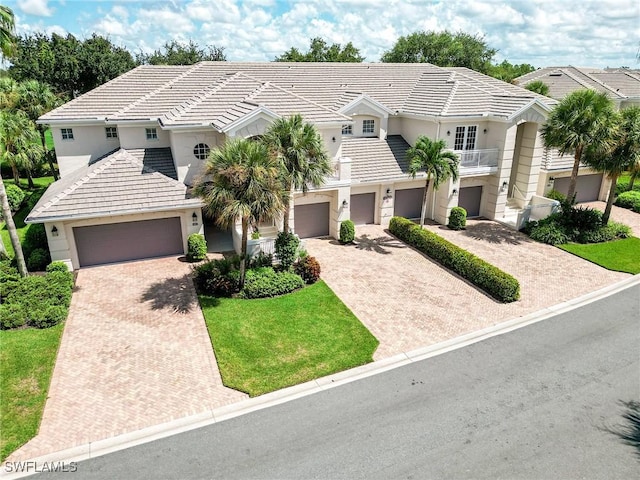 view of front of home with a garage and a front lawn