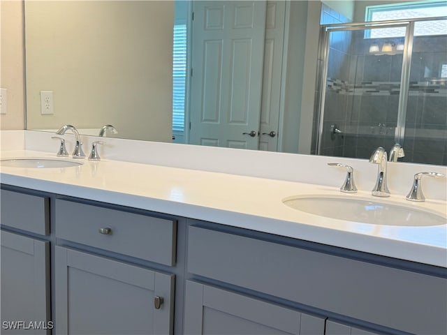 bathroom with walk in shower and vanity