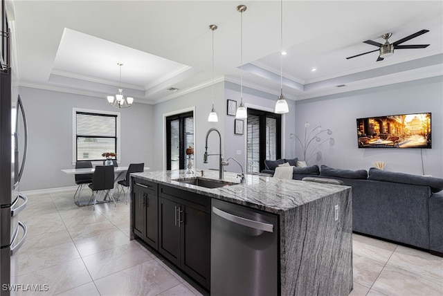 kitchen featuring a tray ceiling, appliances with stainless steel finishes, sink, and light stone counters