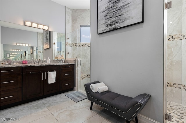 bathroom with an enclosed shower, vanity, and tile patterned floors