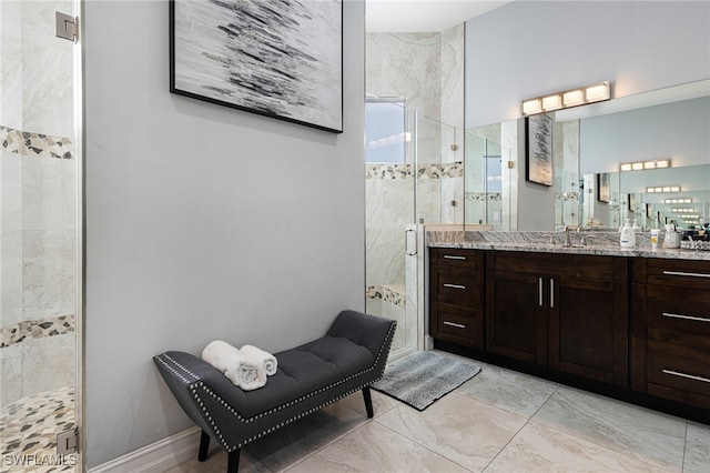 bathroom with tile patterned flooring, an enclosed shower, and vanity