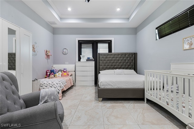 tiled bedroom featuring a tray ceiling