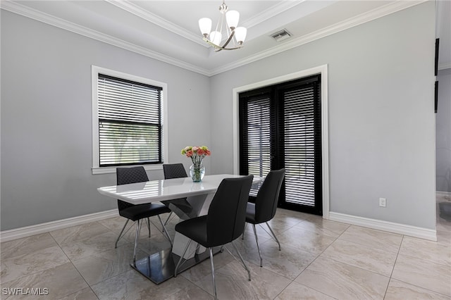 tiled dining space with an inviting chandelier, a tray ceiling, and ornamental molding