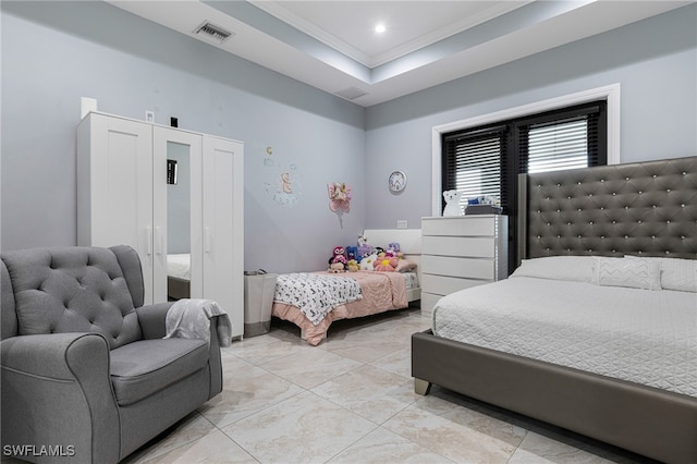 tiled bedroom featuring a tray ceiling