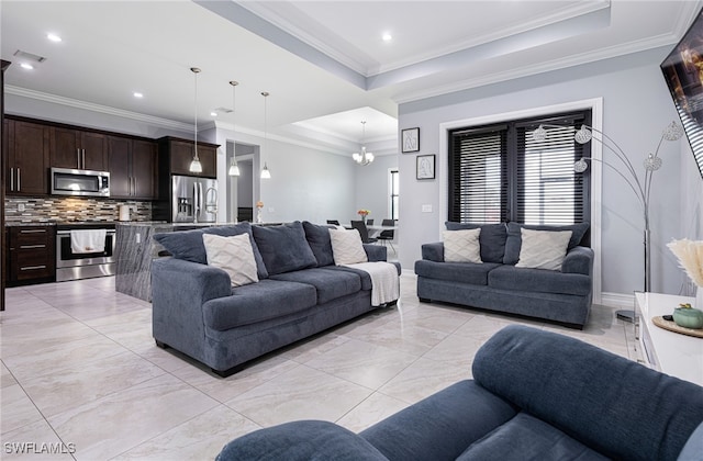 living room featuring crown molding, a tray ceiling, a chandelier, and light tile patterned floors