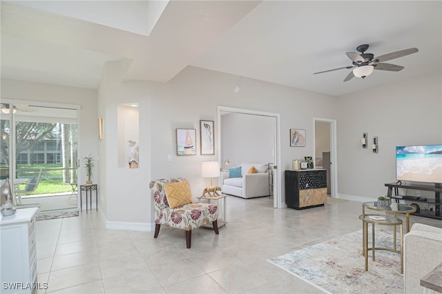 tiled living room with ceiling fan