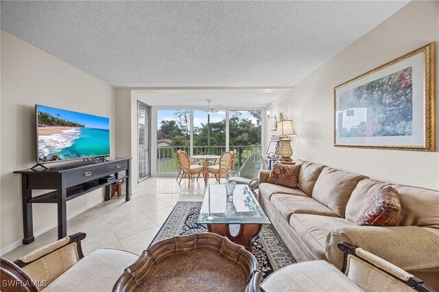 living room featuring light tile patterned flooring and a textured ceiling