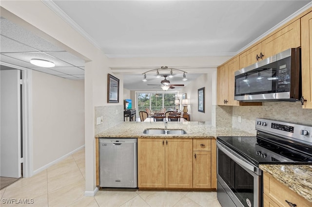 kitchen with ceiling fan, sink, stainless steel appliances, and light stone counters