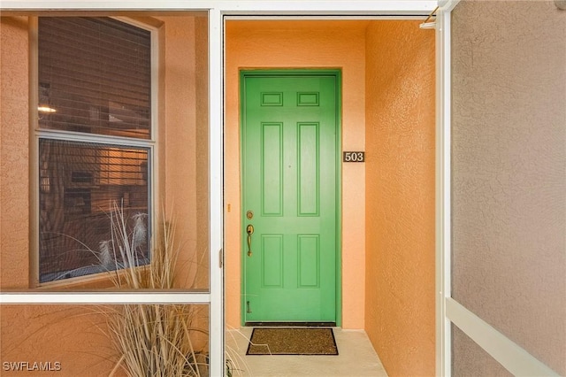 150 Lenell Rd Unit 503, Fort Myers Beach, FL 33931 - doorway to property with stucco siding