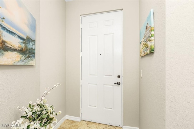 150 Lenell Rd Unit 503, Fort Myers Beach, FL 33931 - doorway with baseboards and light tile patterned flooring