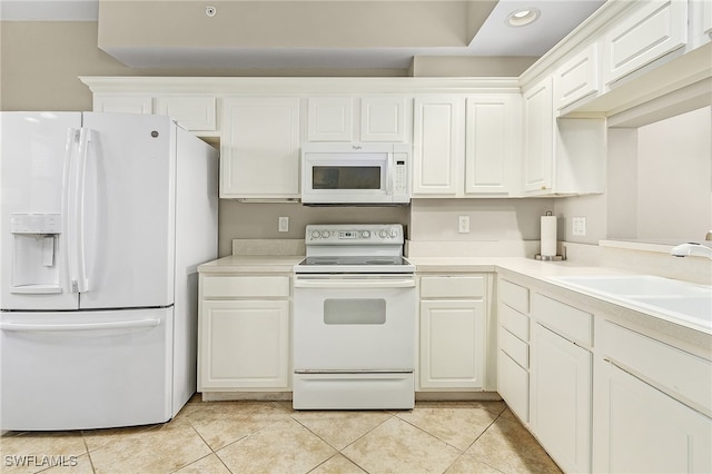 kitchen featuring white cabinets, white appliances, light tile patterned floors, and sink