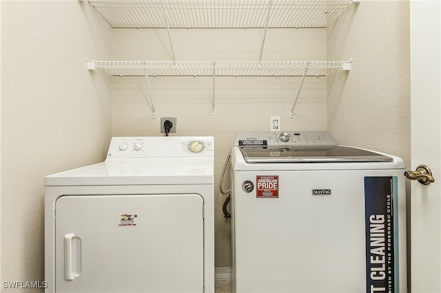 clothes washing area featuring washing machine and clothes dryer