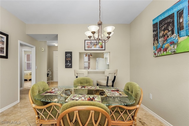 dining space featuring an inviting chandelier and light tile patterned floors