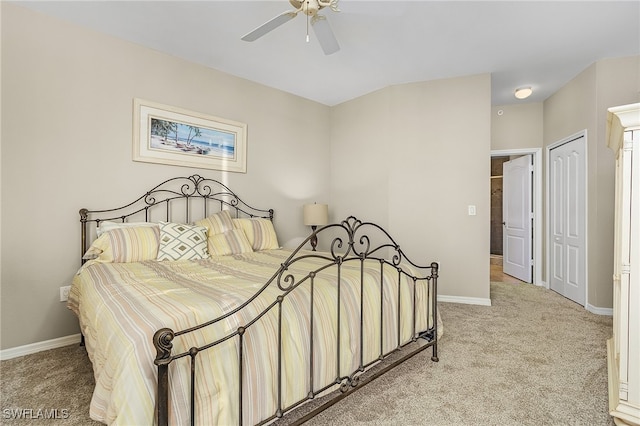 bedroom with a closet, ceiling fan, and light carpet