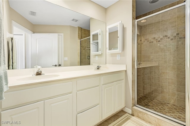 bathroom with vanity and a shower with shower door