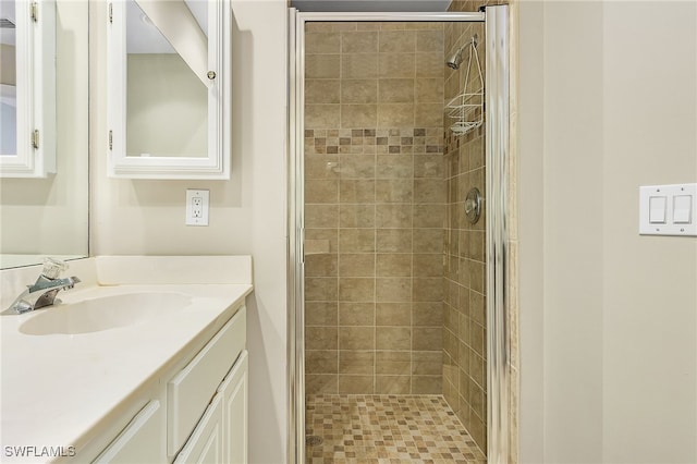 bathroom with vanity and a shower with shower door