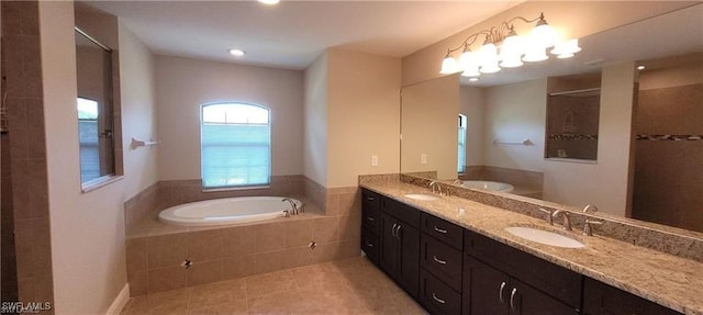 bathroom featuring shower with separate bathtub, tile patterned floors, and vanity