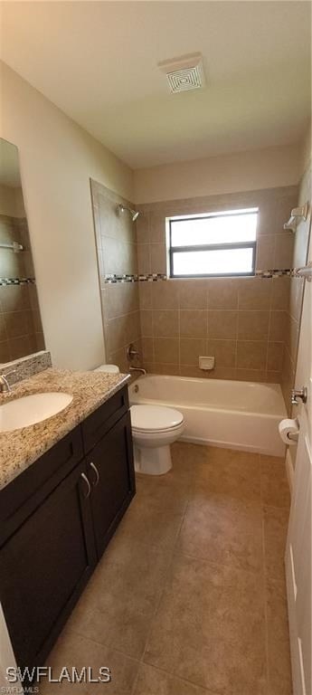 full bathroom with vanity, tile patterned flooring, toilet, and tiled shower / bath combo