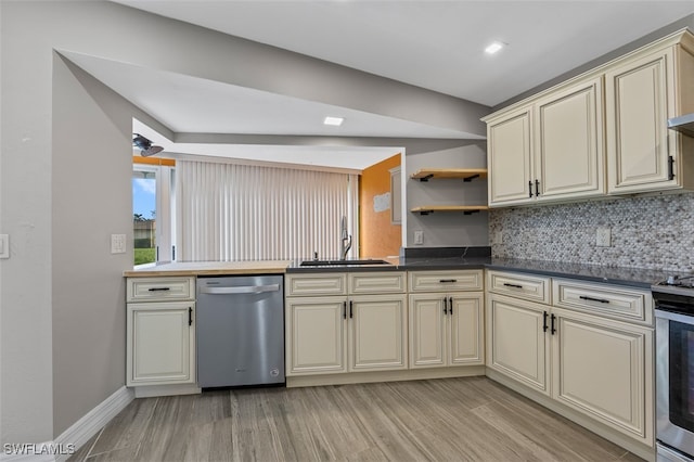 kitchen with light wood-type flooring, sink, appliances with stainless steel finishes, and cream cabinetry