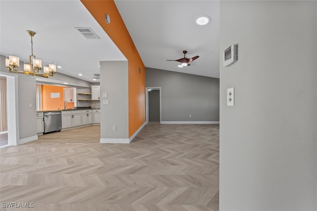 unfurnished living room featuring ceiling fan with notable chandelier, light parquet floors, lofted ceiling, and sink