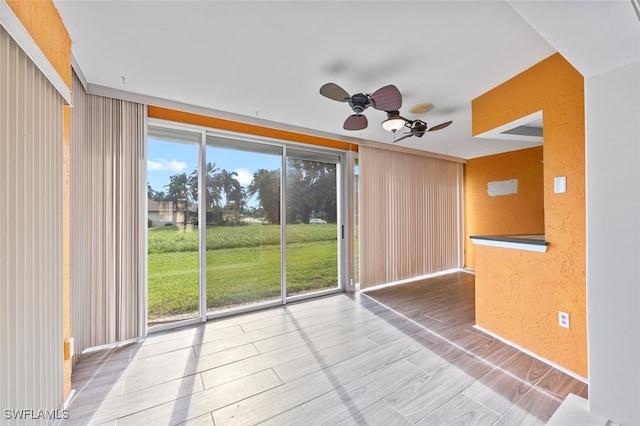 spare room featuring ceiling fan and hardwood / wood-style flooring