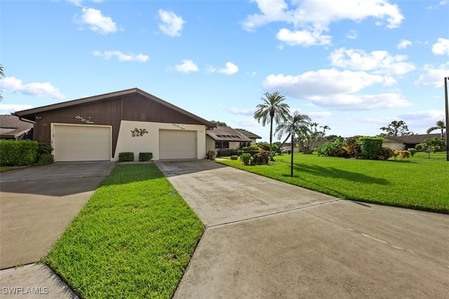 ranch-style home with a front yard and a garage