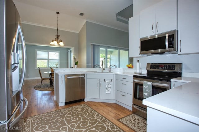 kitchen featuring stainless steel appliances, sink, a notable chandelier, and light hardwood / wood-style flooring