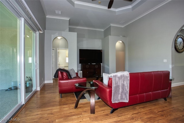 living room with ornamental molding, a wealth of natural light, hardwood / wood-style floors, and ceiling fan