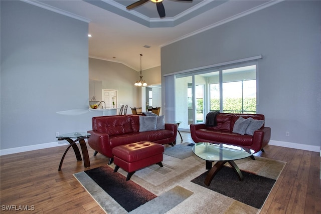 living room with lofted ceiling, ceiling fan with notable chandelier, crown molding, and wood-type flooring