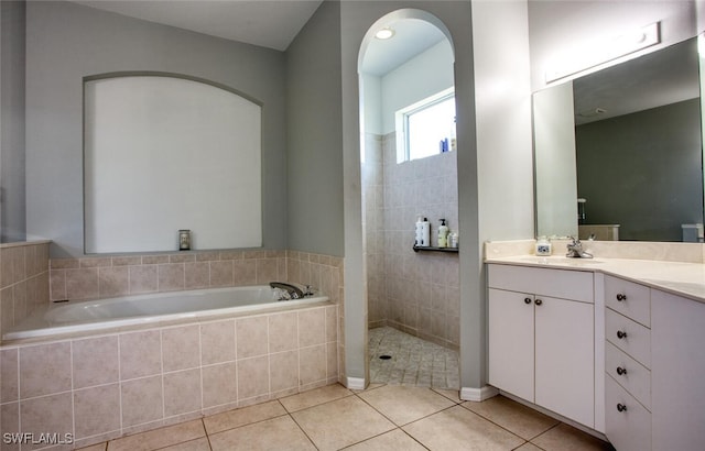 bathroom with vanity, tile patterned floors, and shower with separate bathtub