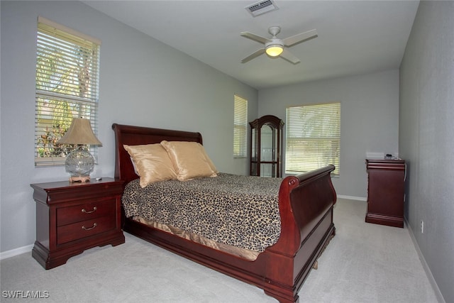 bedroom featuring light carpet and ceiling fan