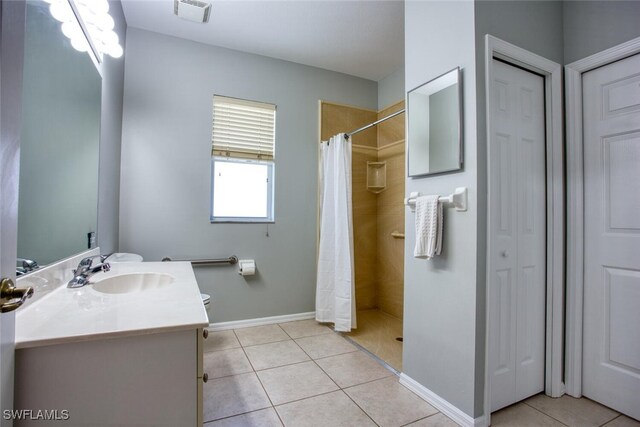 bathroom featuring tile patterned floors, a shower with curtain, toilet, and vanity