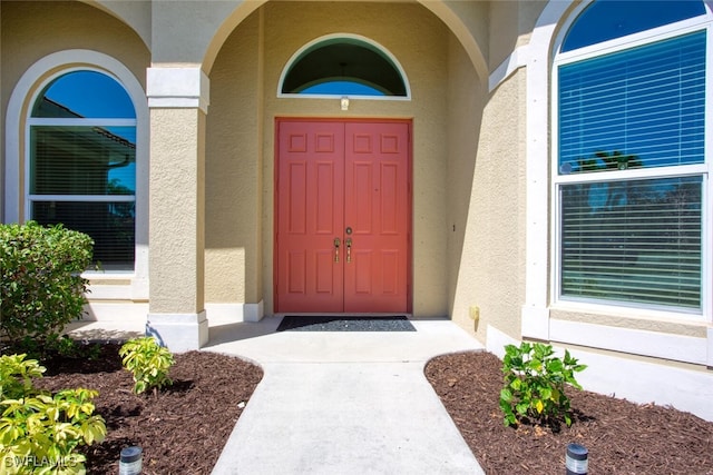 doorway to property with stucco siding