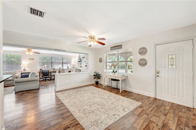 living room with wood-type flooring and ceiling fan