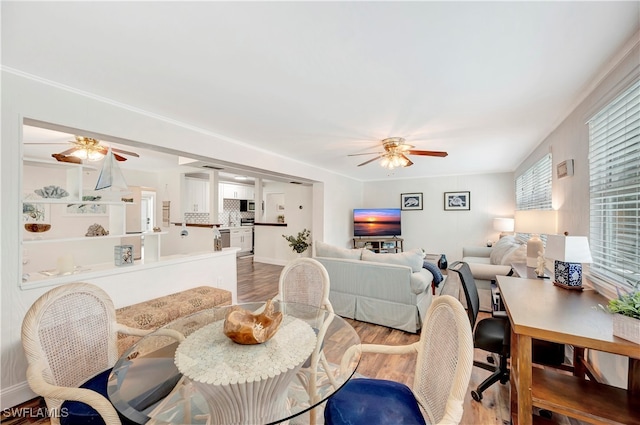 dining space with ceiling fan and light hardwood / wood-style floors