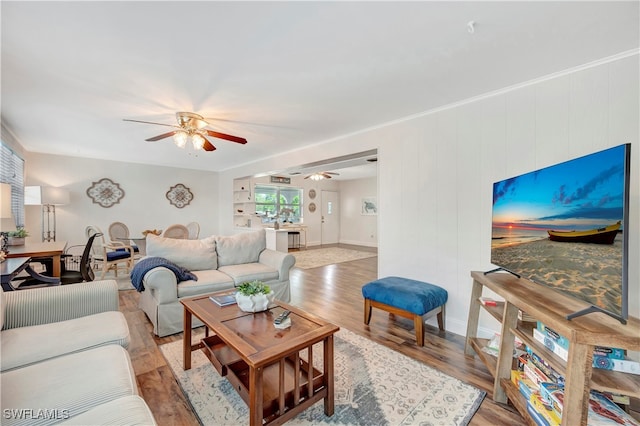 living room featuring light hardwood / wood-style flooring and ceiling fan