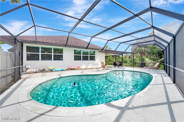 view of pool with a lanai and a patio