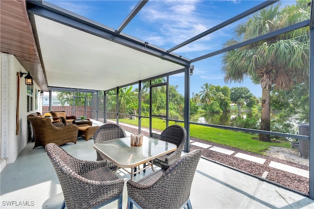 sunroom / solarium with a water view