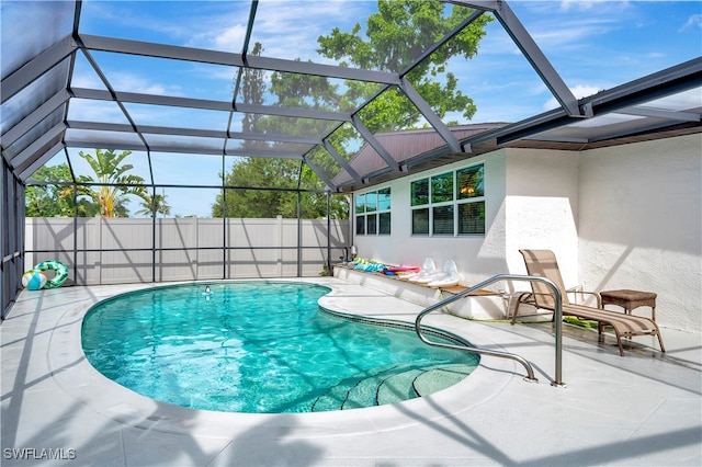 view of swimming pool with a lanai and a patio area