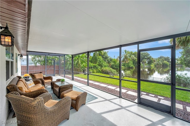 sunroom / solarium featuring a water view and a wealth of natural light