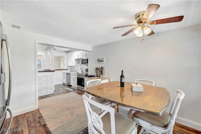 dining area featuring ceiling fan and wood-type flooring