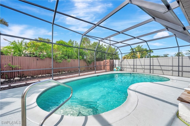 view of swimming pool with a patio and a lanai